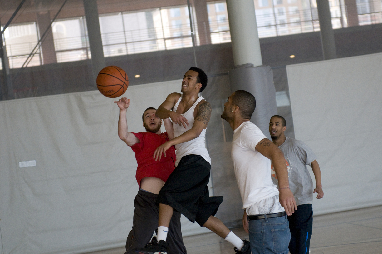 Group playing basketball in rec center